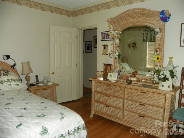 a bed sitting in a bedroom next to a window