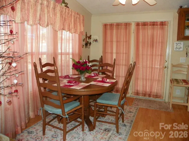 a view of a dining room with furniture and window