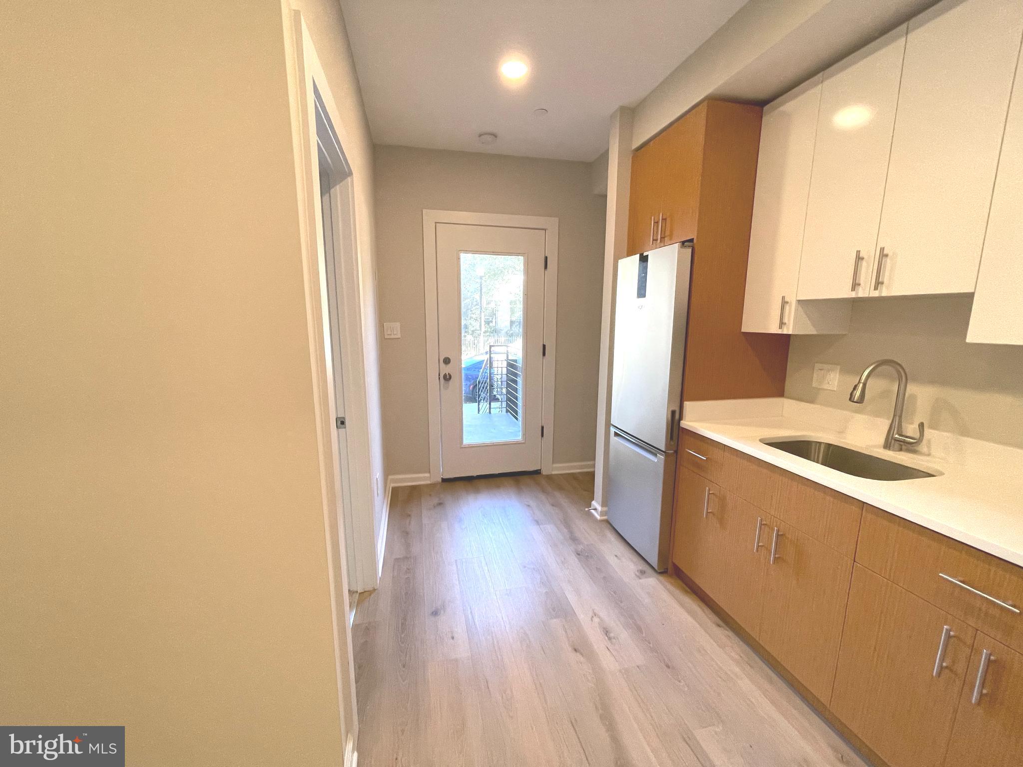 1307 K Street Southeast, Unit 101 Washington, DC 20003 - Photo 4 of 8 a kitchen with a sink and refrigerator