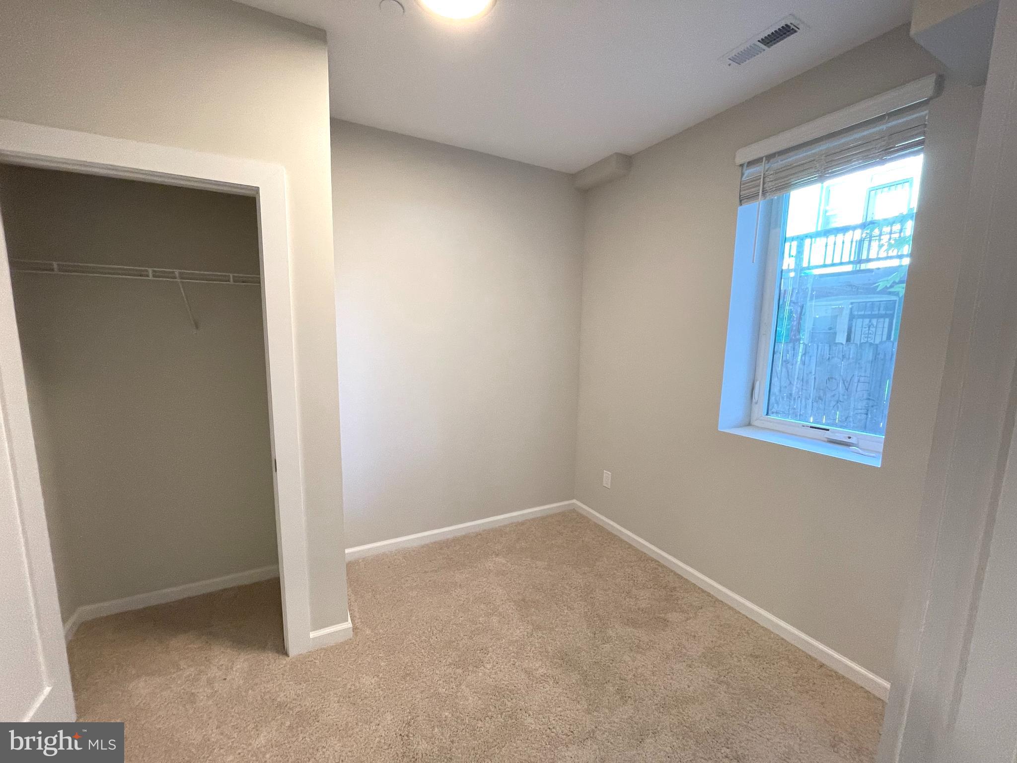 1307 K Street Southeast, Unit 101 Washington, DC 20003 - Photo 7 of 8 an empty room with windows and closet