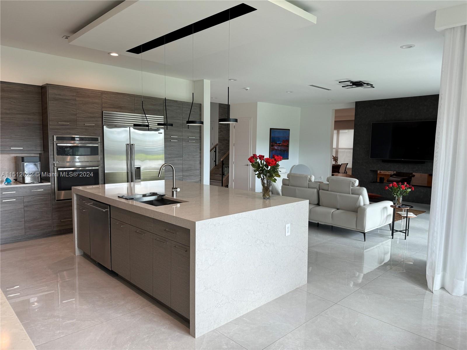 8636 Dearborn River Way Boca Raton, FL 33496 - Photo 11 of 25 a kitchen with stainless steel appliances kitchen island granite countertop a stove and a sink
