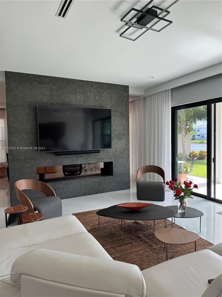 8636 Dearborn River Way Boca Raton, FL 33496 - Photo 12 of 25 a living room with furniture and a flat screen tv