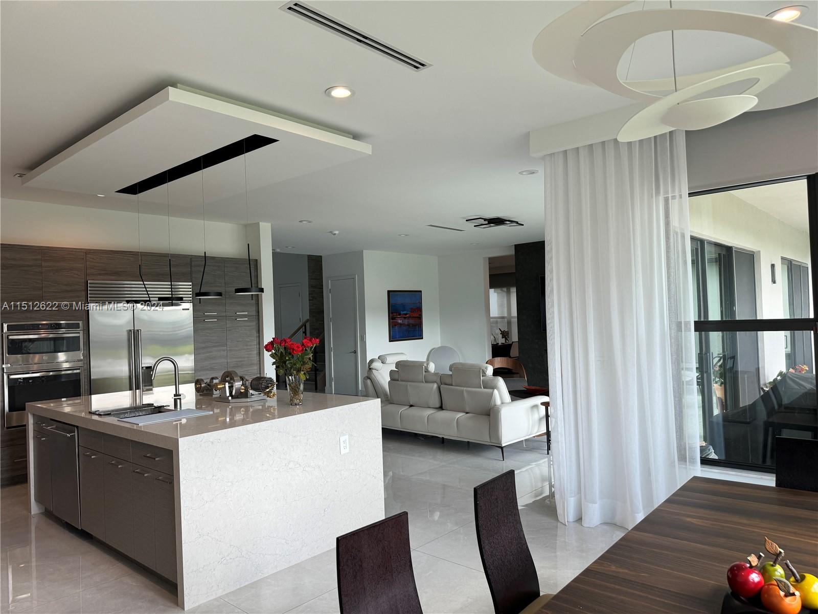 8636 Dearborn River Way Boca Raton, FL 33496 - Photo 13 of 25 a kitchen with stainless steel appliances kitchen island granite countertop a refrigerator and a stove