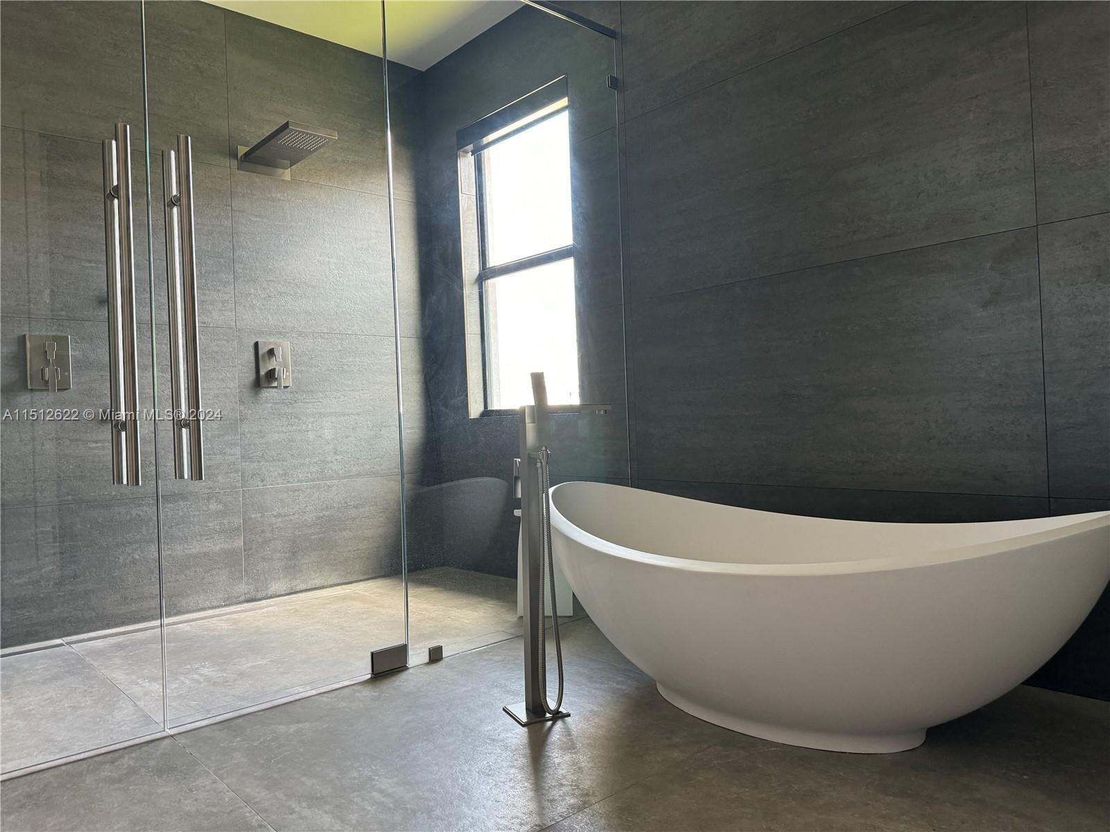 8636 Dearborn River Way Boca Raton, FL 33496 - Photo 20 of 25 a white bath tub sitting in a bathroom