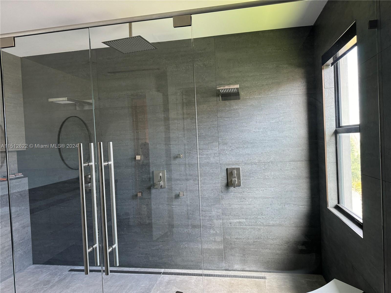 8636 Dearborn River Way Boca Raton, FL 33496 - Photo 22 of 25 a bathroom with a glass shower door