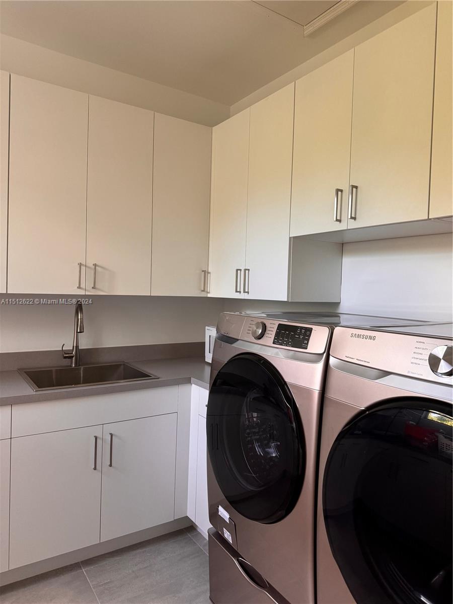8636 Dearborn River Way Boca Raton, FL 33496 - Photo 24 of 25 a kitchen with granite countertop white cabinets and sink