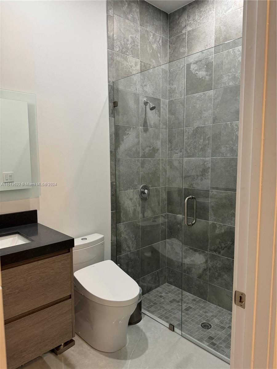 8636 Dearborn River Way Boca Raton, FL 33496 - Photo 25 of 25 a bathroom with a toilet a sink and shower