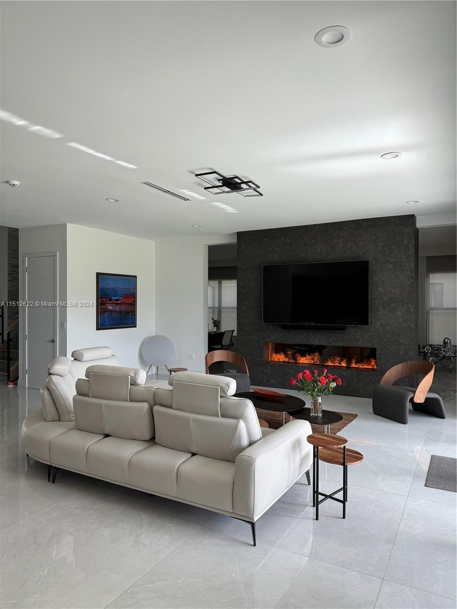 8636 Dearborn River Way Boca Raton, FL 33496 - Photo 4 of 25 a living room with furniture and a flat screen tv