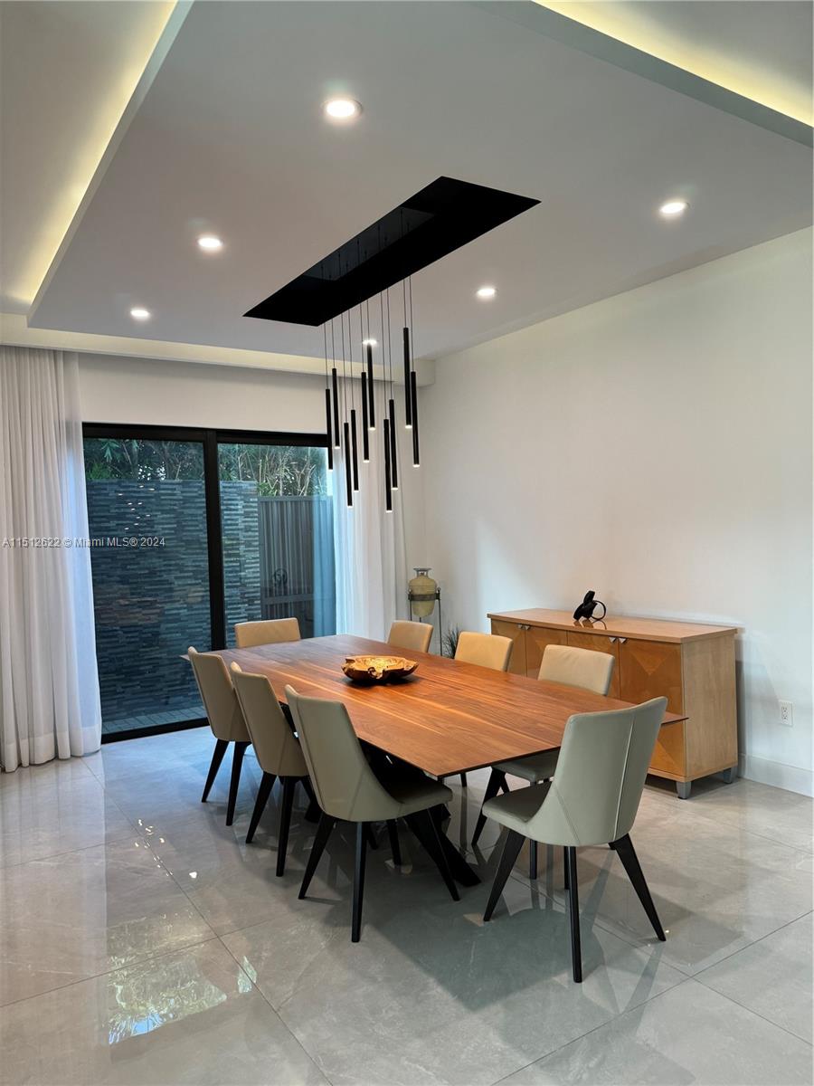 8636 Dearborn River Way Boca Raton, FL 33496 - Photo 6 of 25 a dining room with a table and chairs