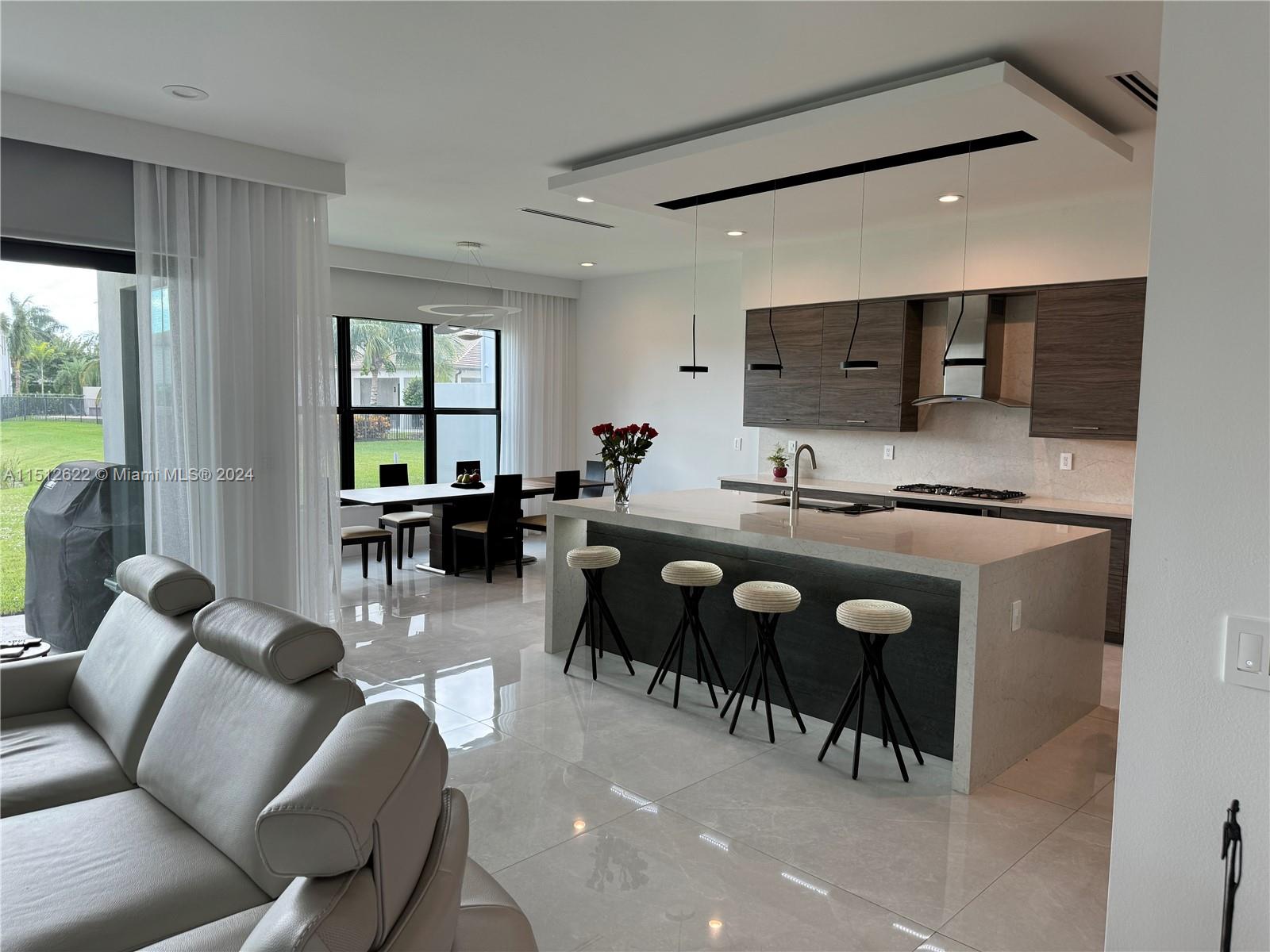 8636 Dearborn River Way Boca Raton, FL 33496 - Photo 7 of 25 a living room with furniture a flat screen tv and a large window