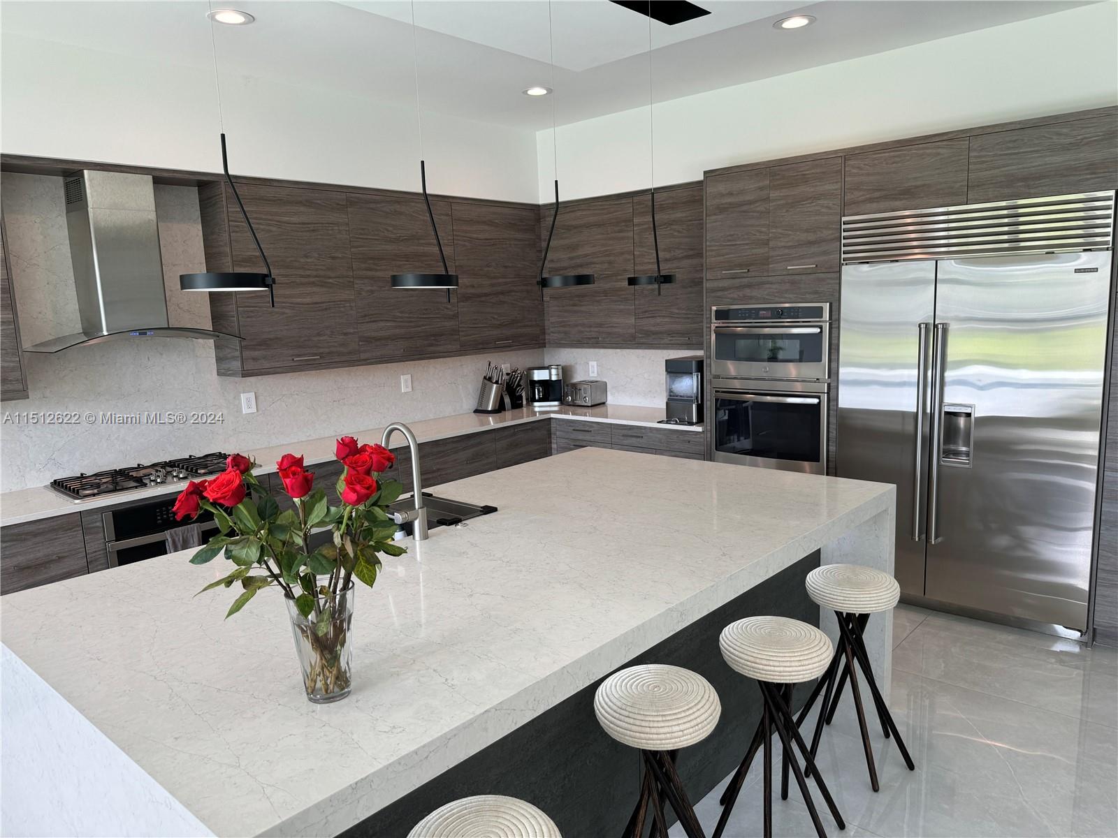8636 Dearborn River Way Boca Raton, FL 33496 - Photo 10 of 25 a kitchen with stainless steel appliances granite countertop a sink a stove and a refrigerator