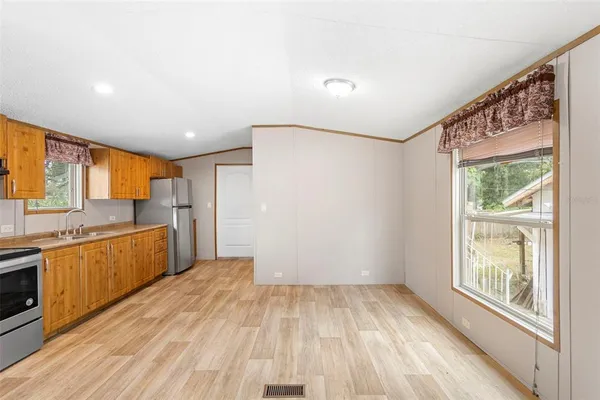 a view of a kitchen with a sink and wooden floor