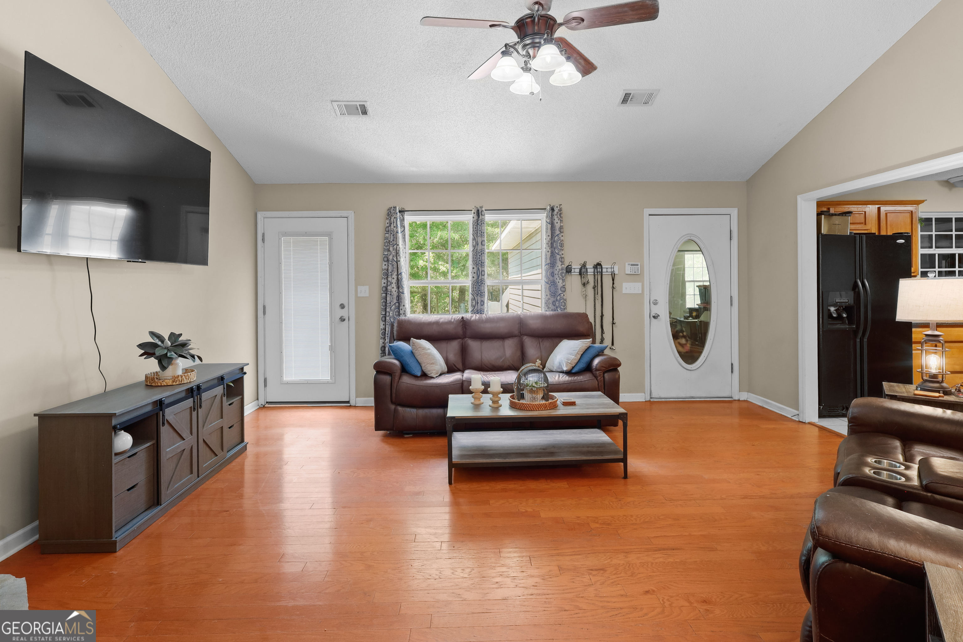 136 Quail Knoll Road Danville, GA 31017 - Photo 11 of 49 a living room with furniture and a flat screen tv