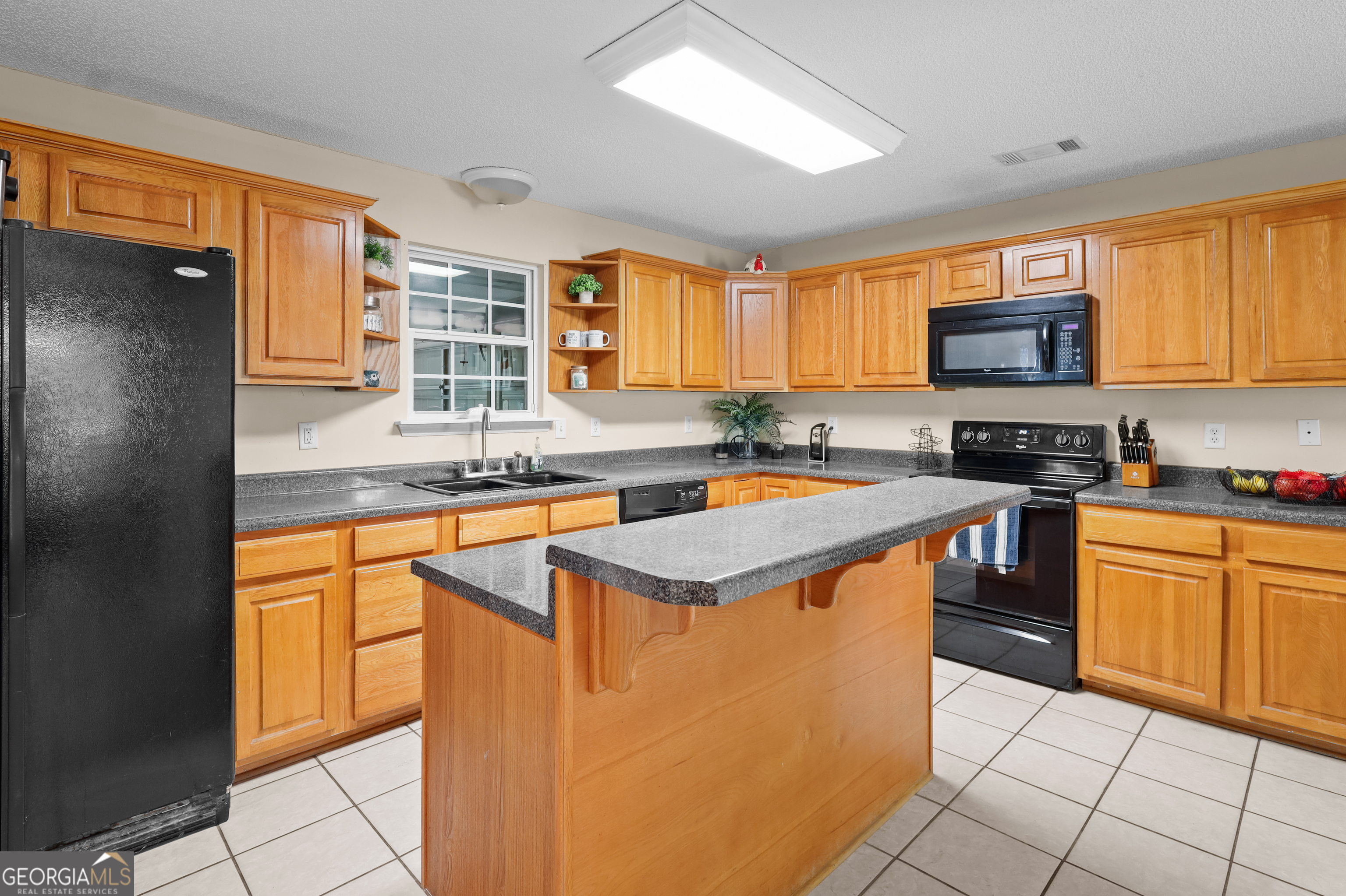 136 Quail Knoll Road Danville, GA 31017 - Photo 13 of 49 a kitchen with stainless steel appliances granite countertop a stove a sink and a refrigerator