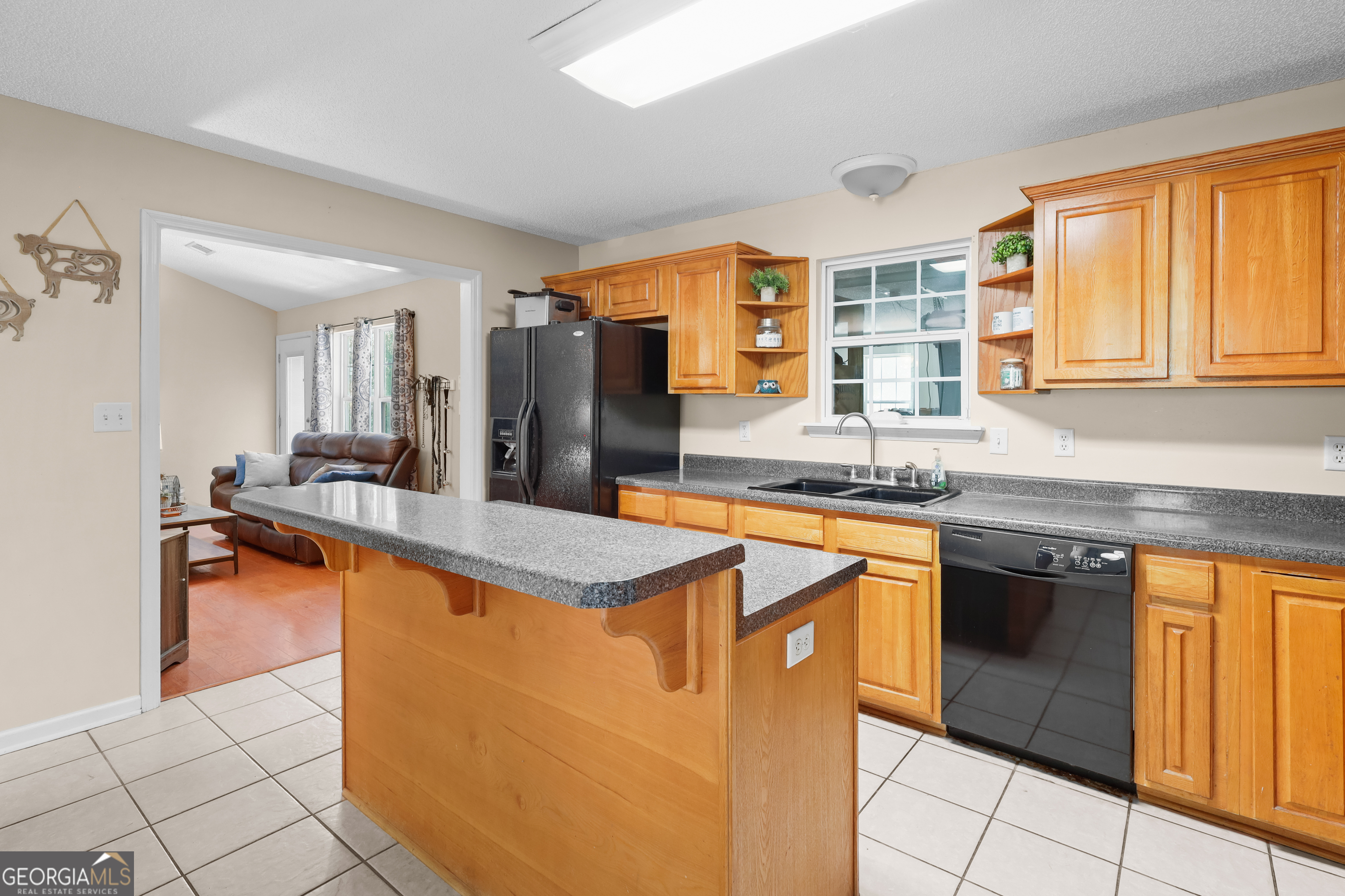 136 Quail Knoll Road Danville, GA 31017 - Photo 14 of 49 a kitchen with stainless steel appliances granite countertop sink stove top oven and cabinets