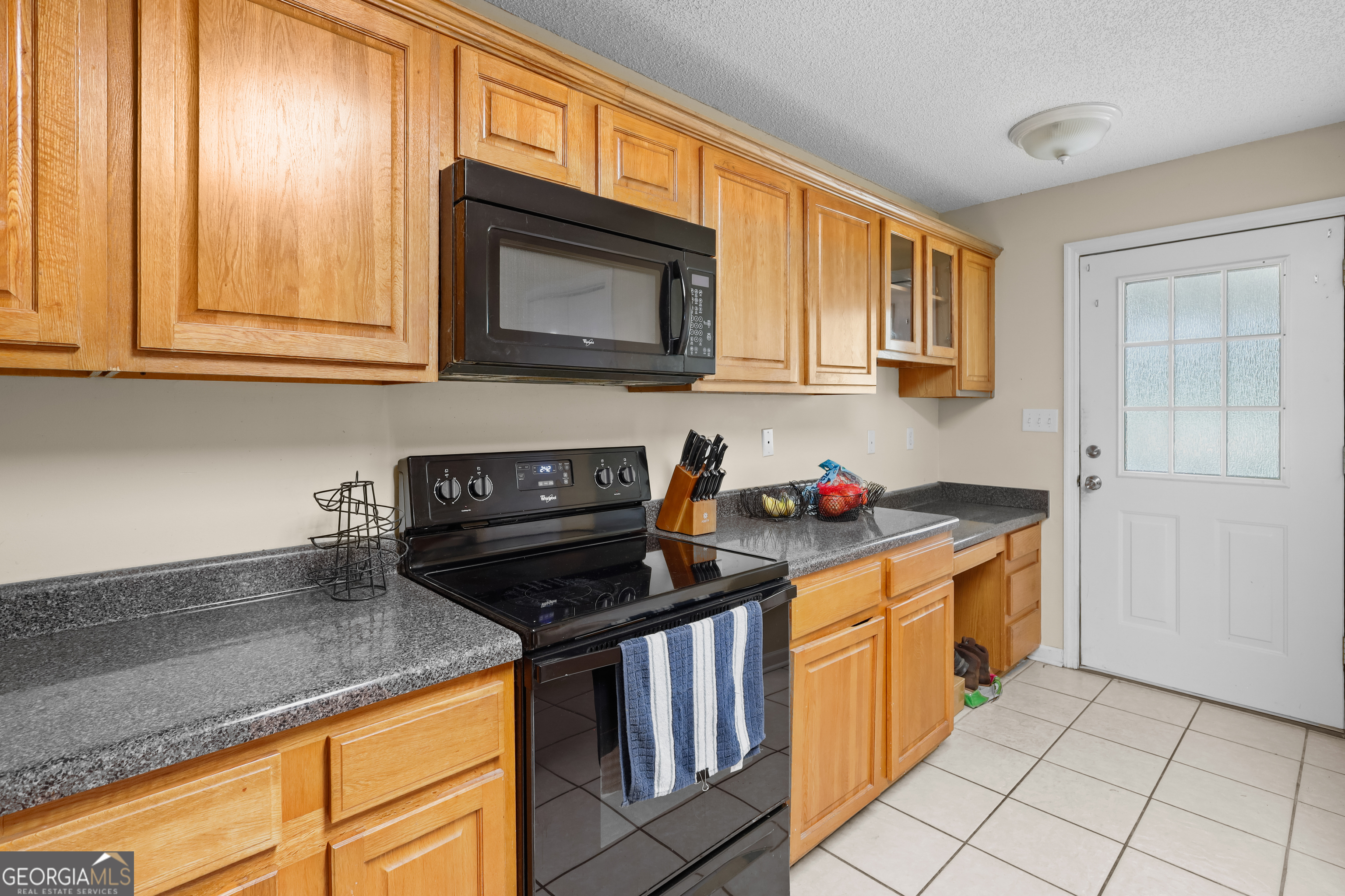 136 Quail Knoll Road Danville, GA 31017 - Photo 15 of 49 a kitchen with stainless steel appliances granite countertop a stove a sink and a microwave