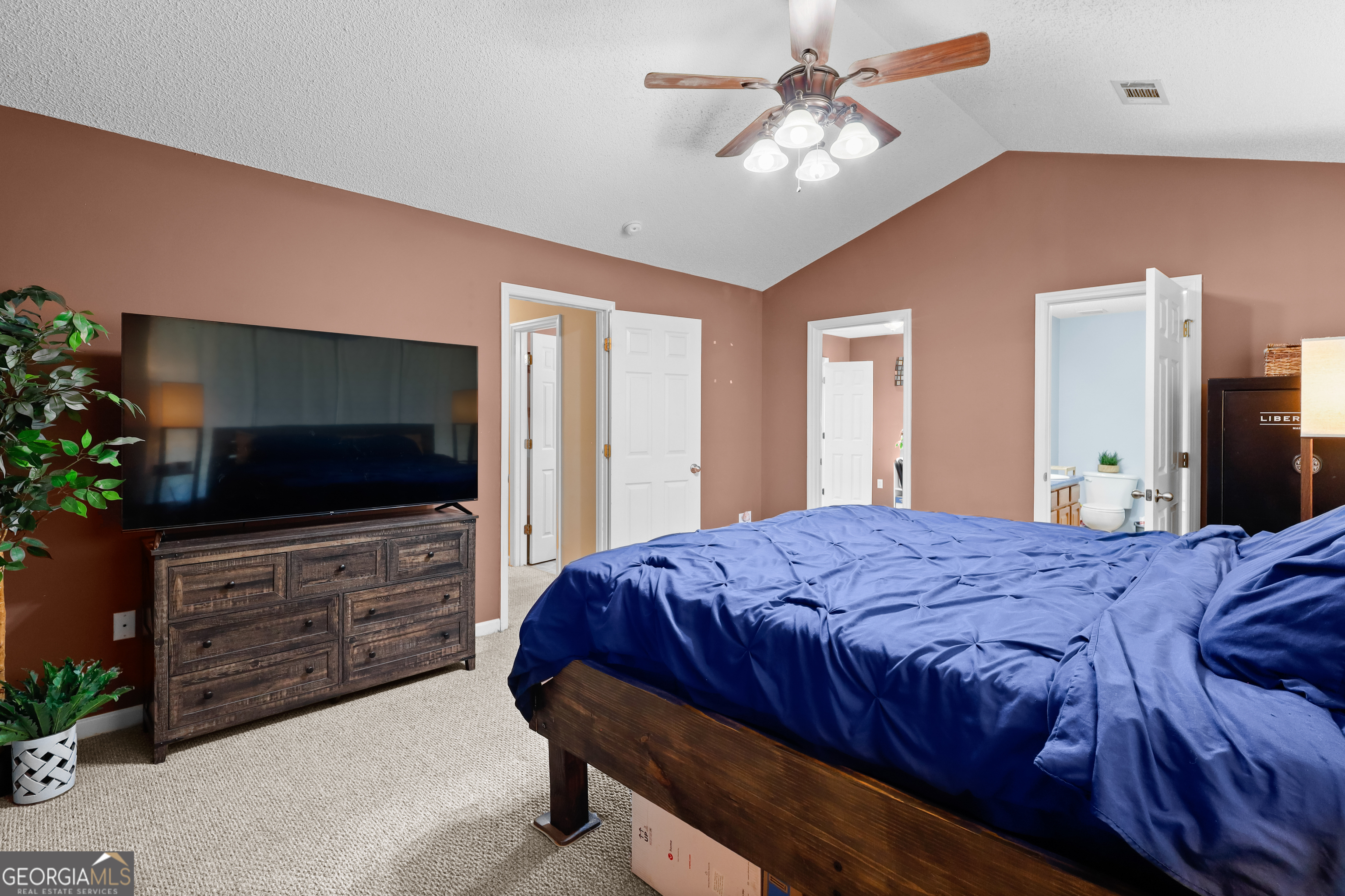 136 Quail Knoll Road Danville, GA 31017 - Photo 17 of 49 a bedroom with a bed and a flat screen tv