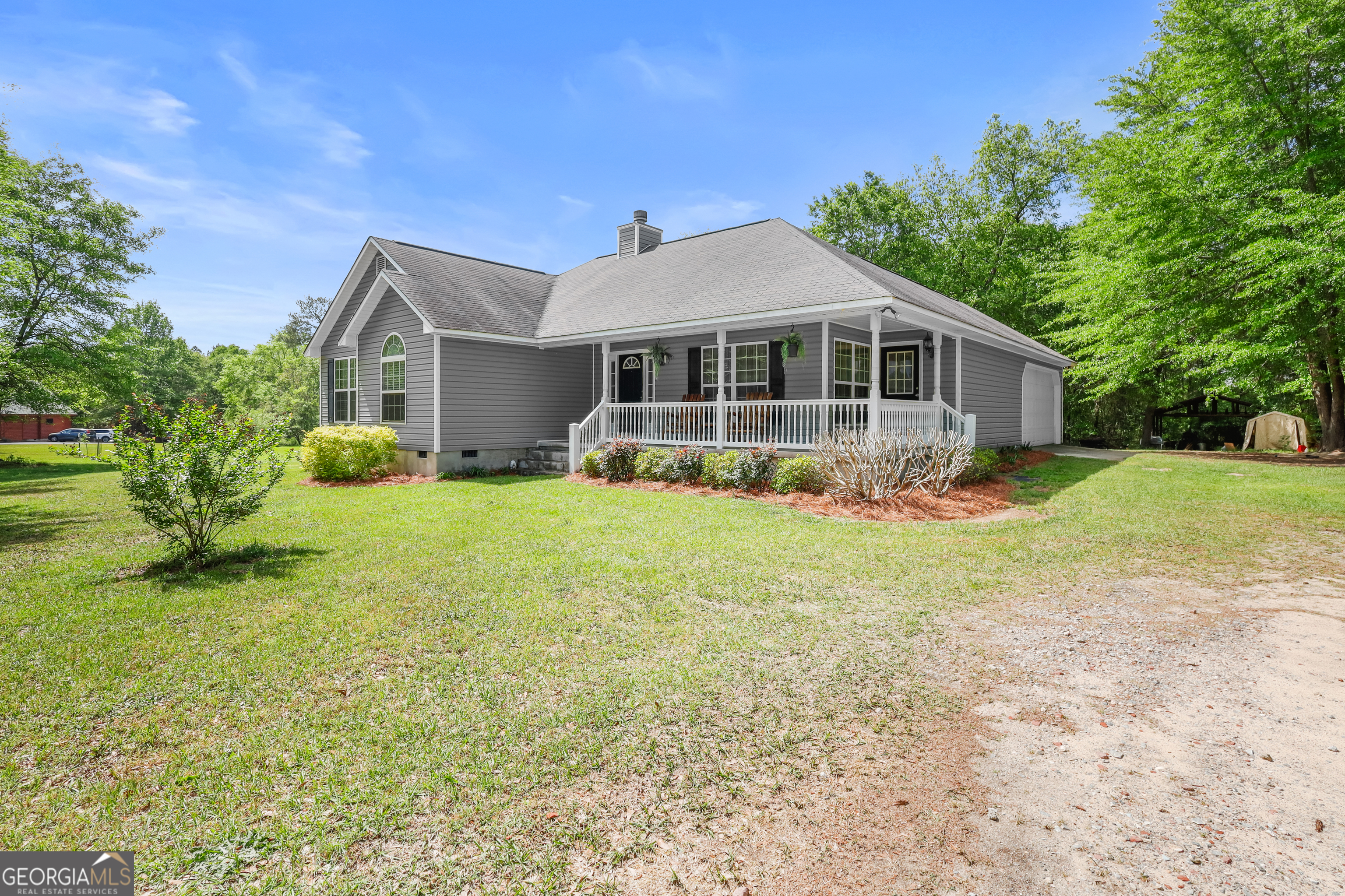 136 Quail Knoll Road Danville, GA 31017 - Photo 2 of 49 a front view of a house with garden