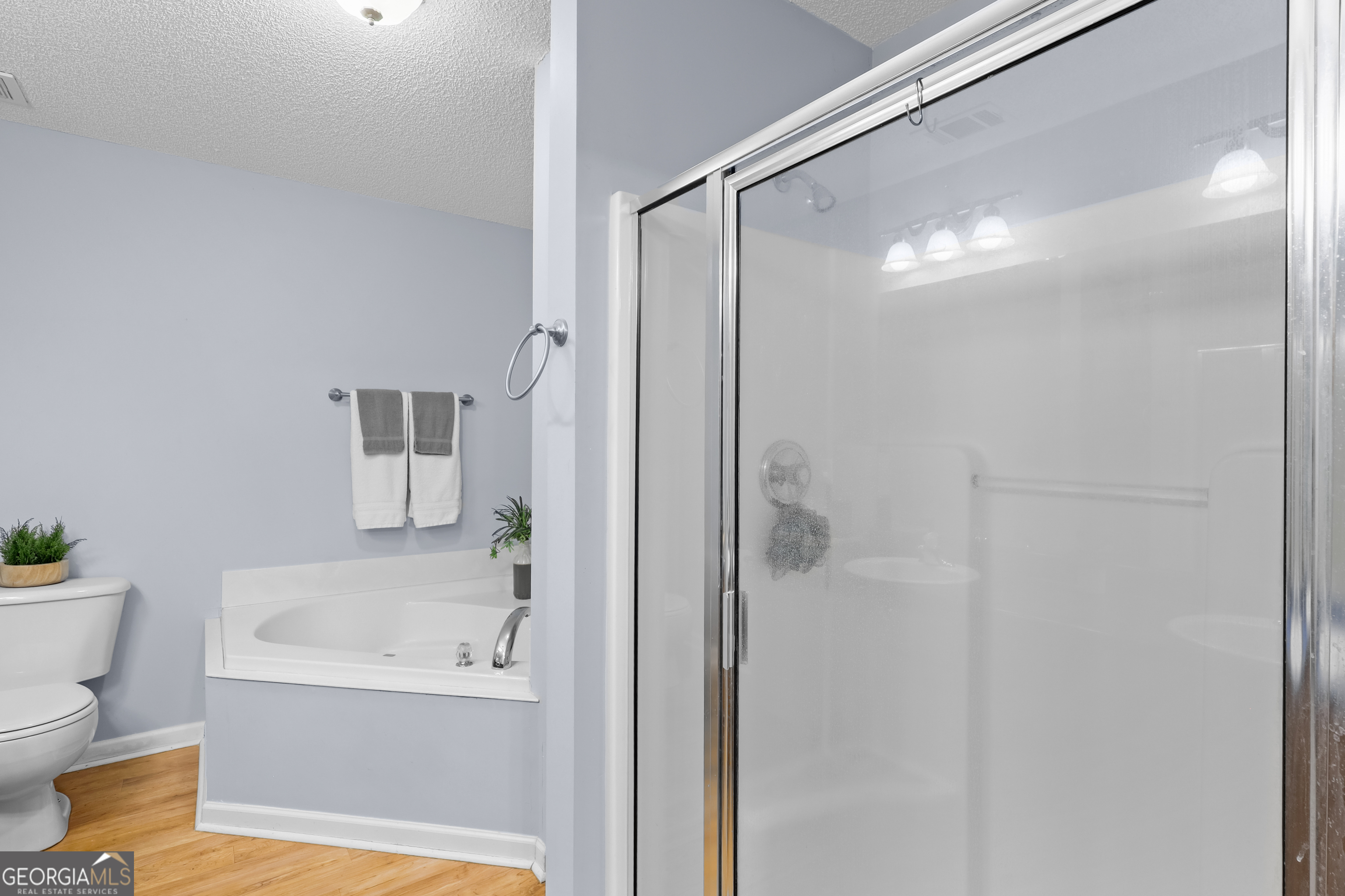 136 Quail Knoll Road Danville, GA 31017 - Photo 25 of 49 a bathroom with a bathtub and a shower