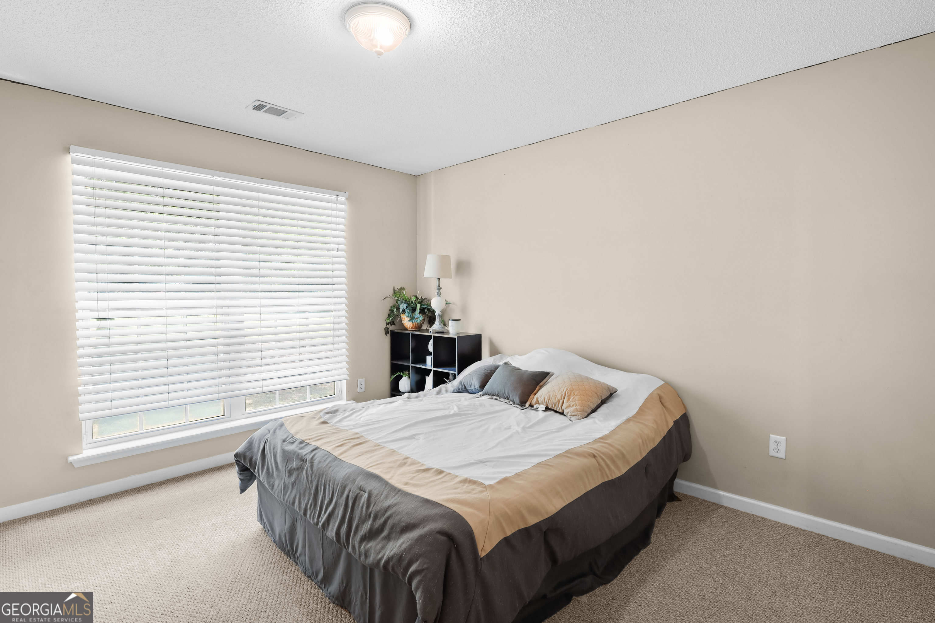 136 Quail Knoll Road Danville, GA 31017 - Photo 29 of 49 a bedroom with a bed and window