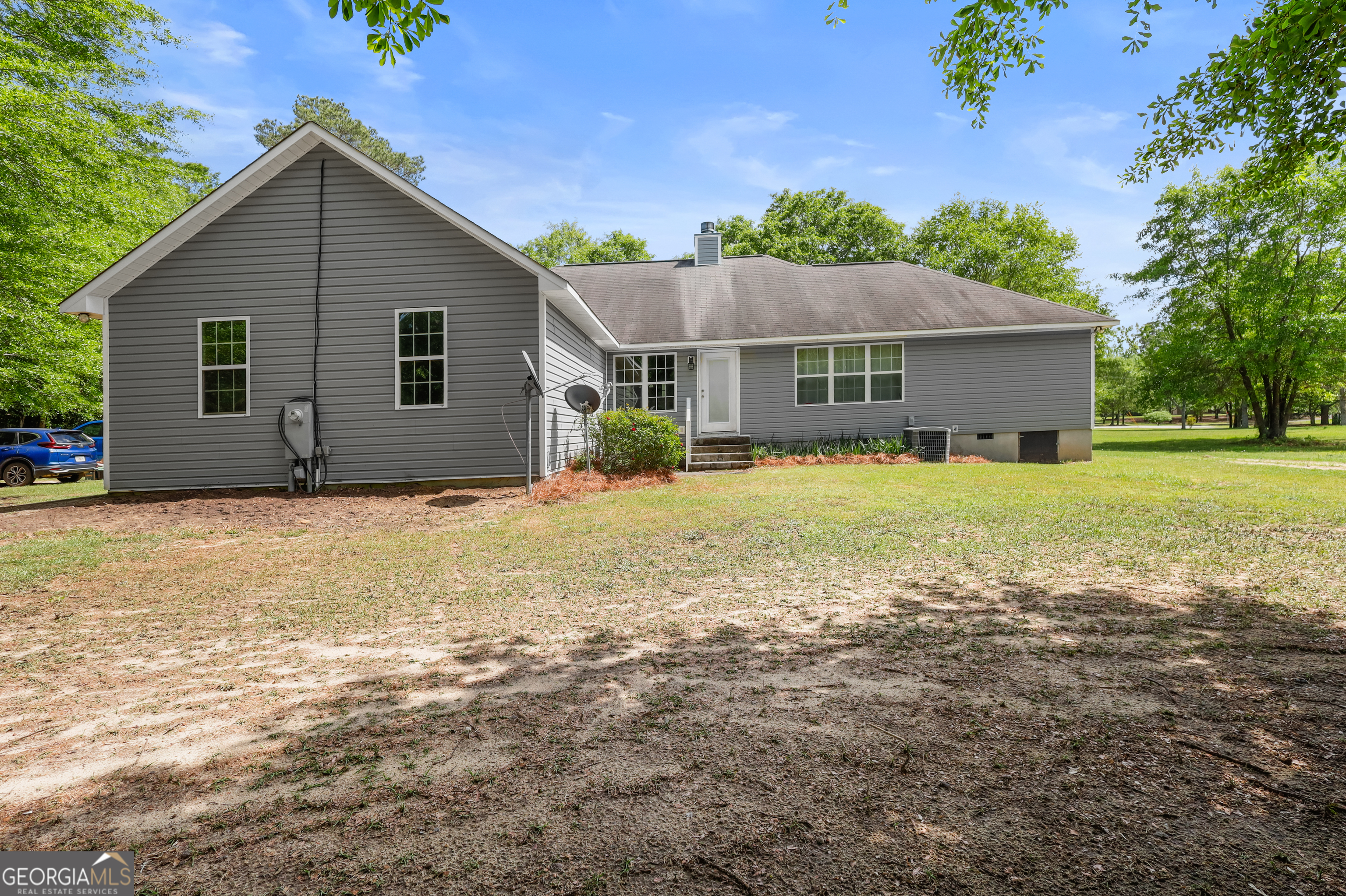 136 Quail Knoll Road Danville, GA 31017 - Photo 4 of 49 a front view of house with yard and trees in the background