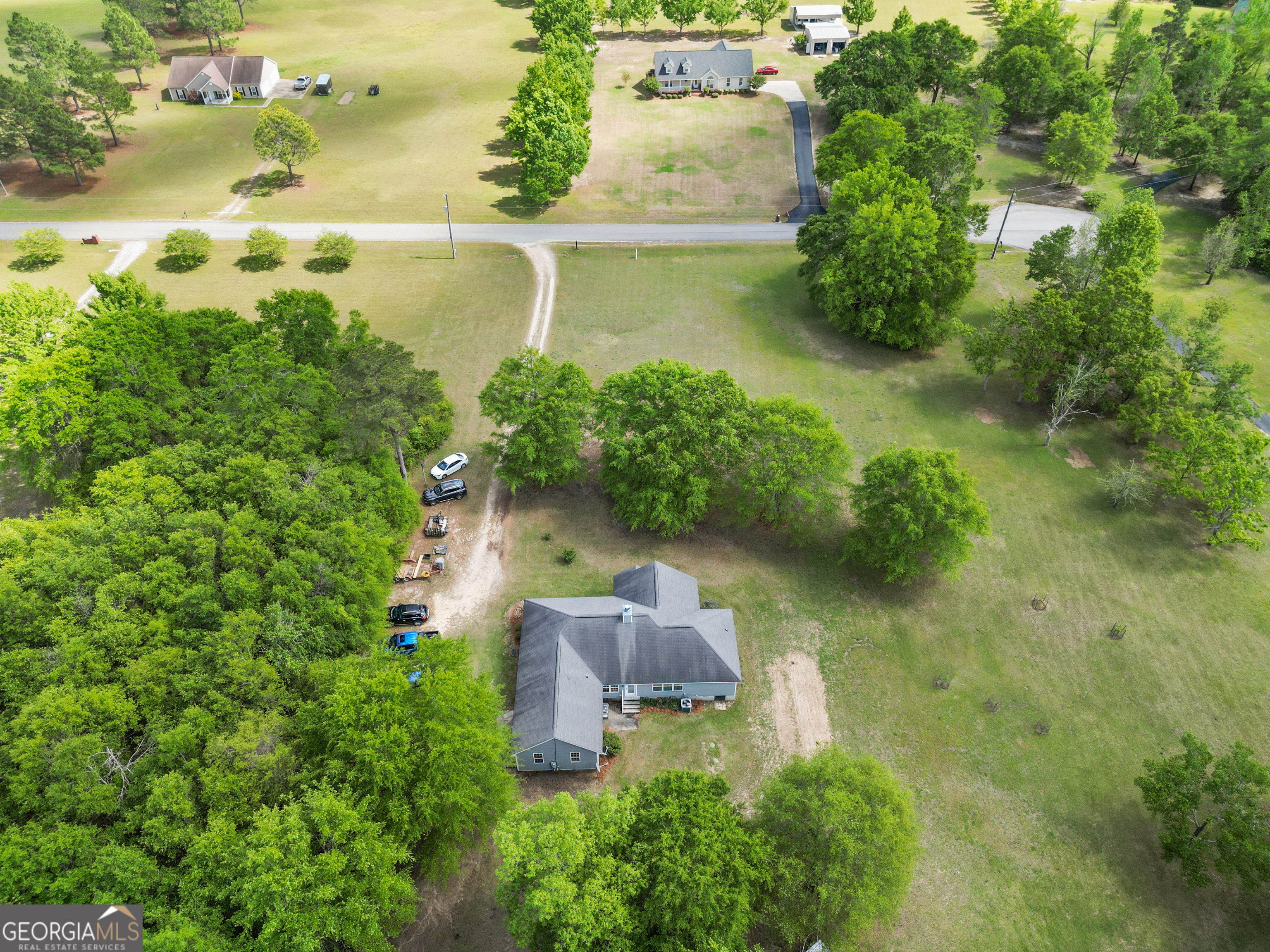 136 Quail Knoll Road Danville, GA 31017 - Photo 44 of 49 an aerial view of a house with a yard and lake view
