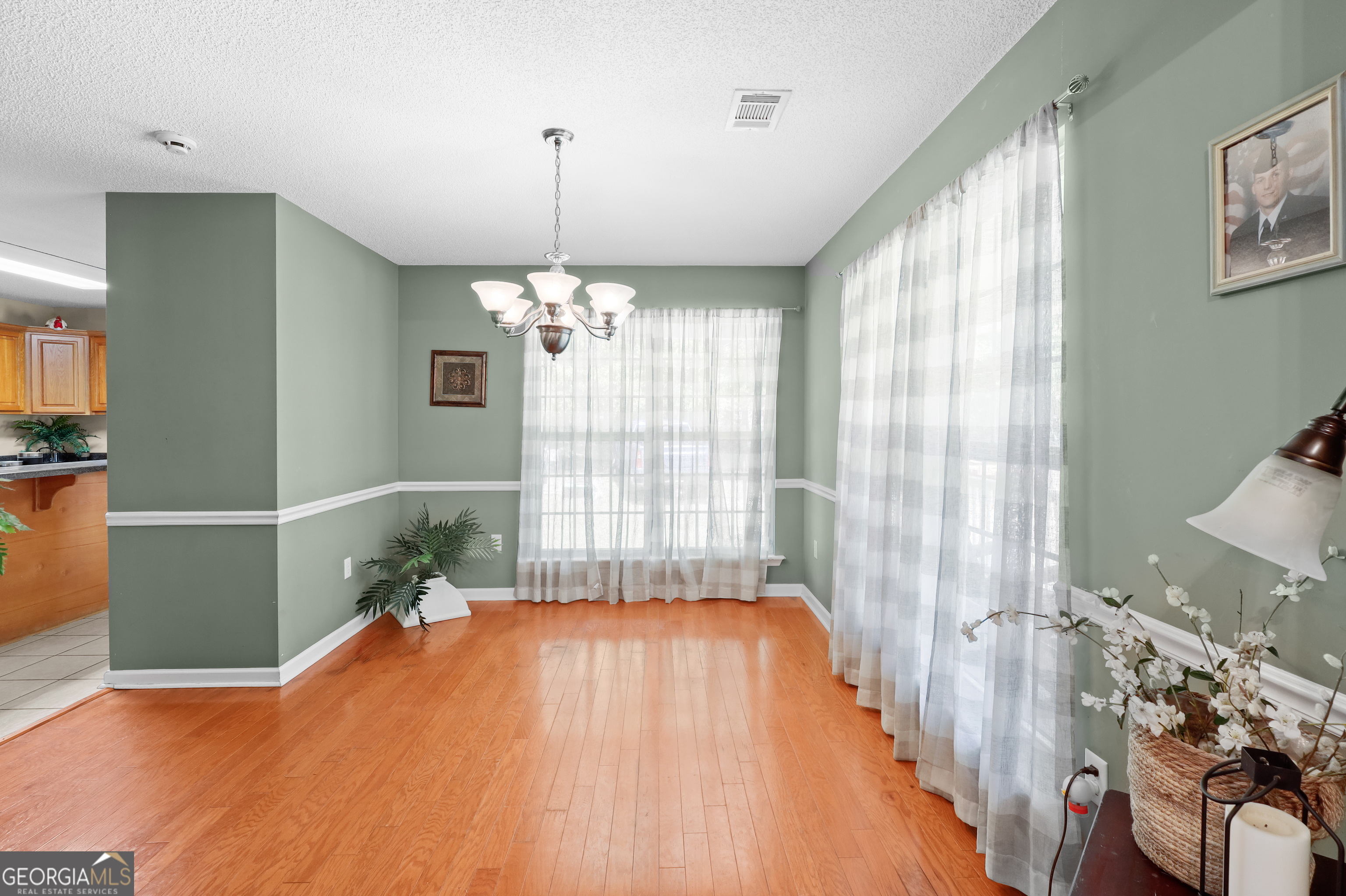 136 Quail Knoll Road Danville, GA 31017 - Photo 8 of 49 a spacious bedroom with a bed and a chandelier