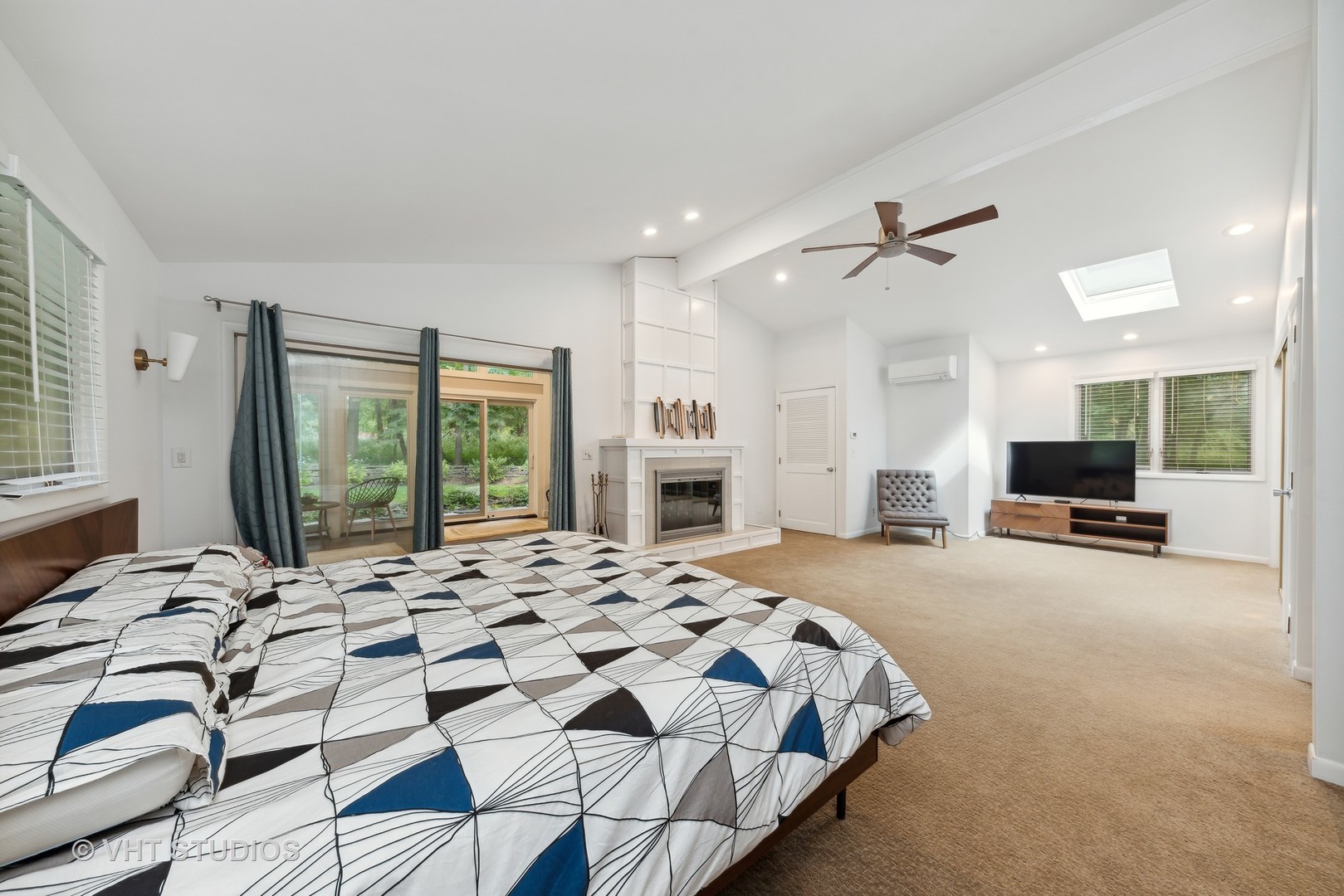 107 Trout Valley Road Trout Valley, IL 60013 - Photo 16 of 29 a spacious bedroom with a bed a fireplace and large windows