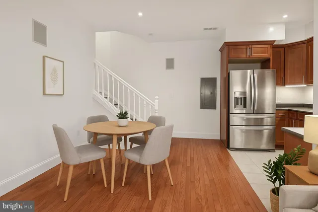 a view of a dining room with furniture and wooden floor