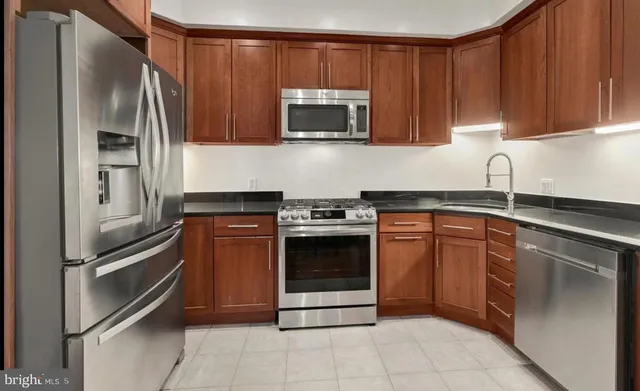 a kitchen with granite countertop stainless steel appliances and cabinets
