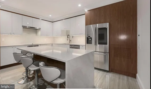 a kitchen with stainless steel appliances a sink and a refrigerator