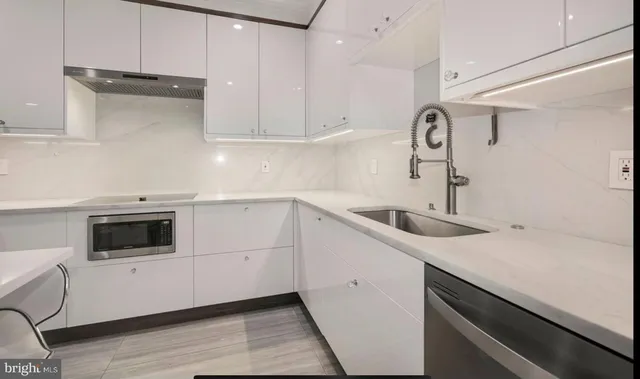 a kitchen with a sink and cabinets
