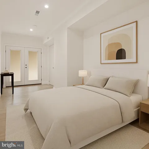 a bedroom with a bed and a painting