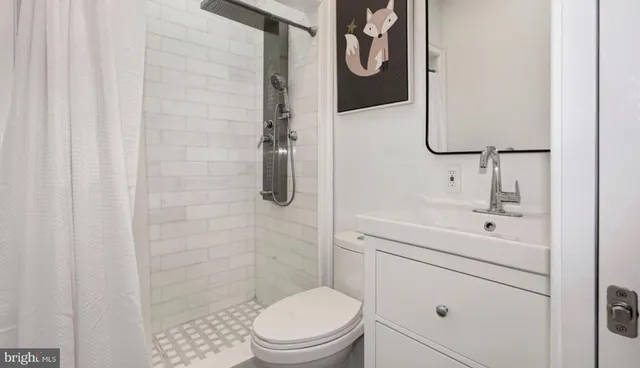 a bathroom with a toilet sink and shower