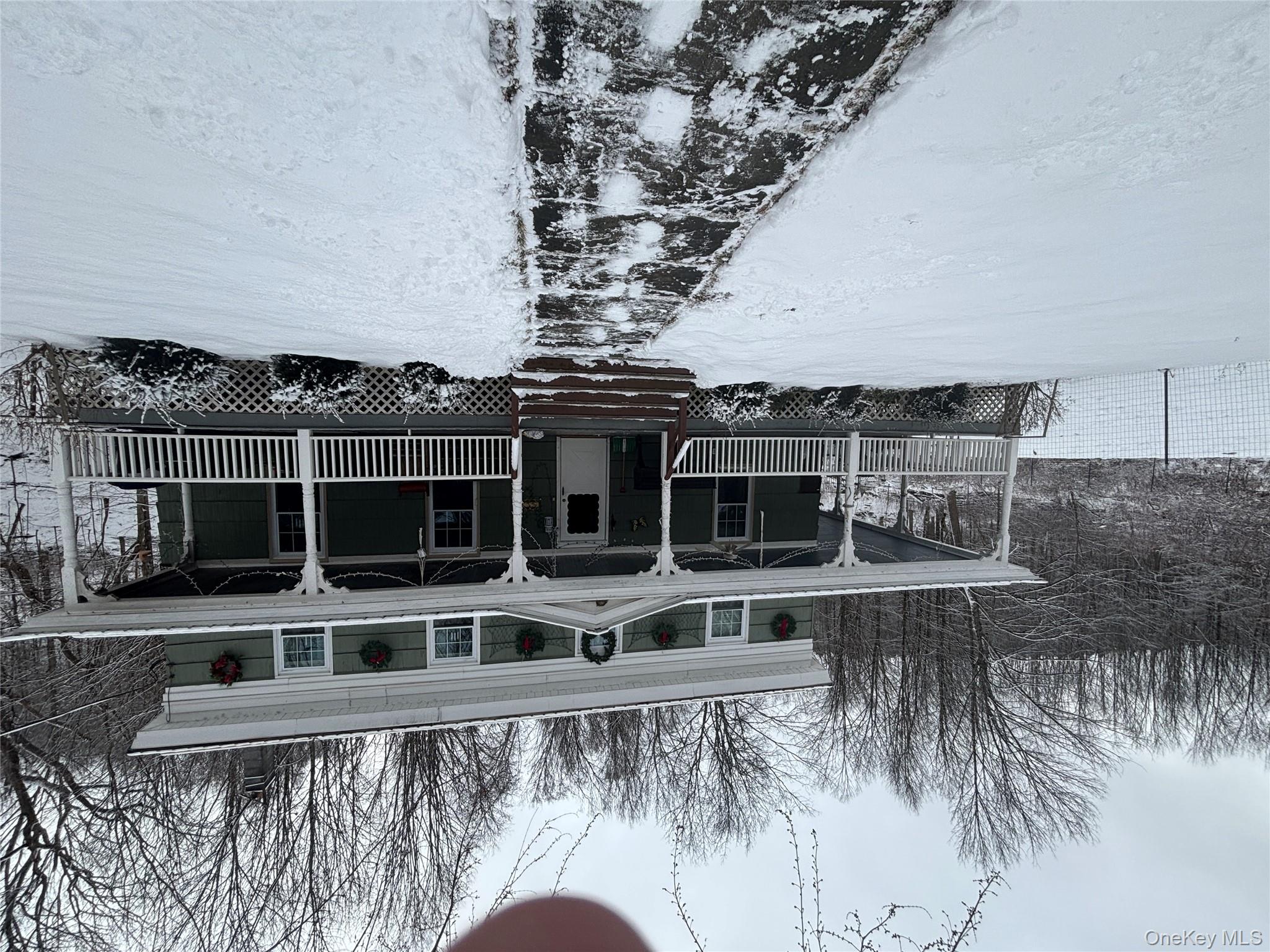a front view of a house with yard and trees