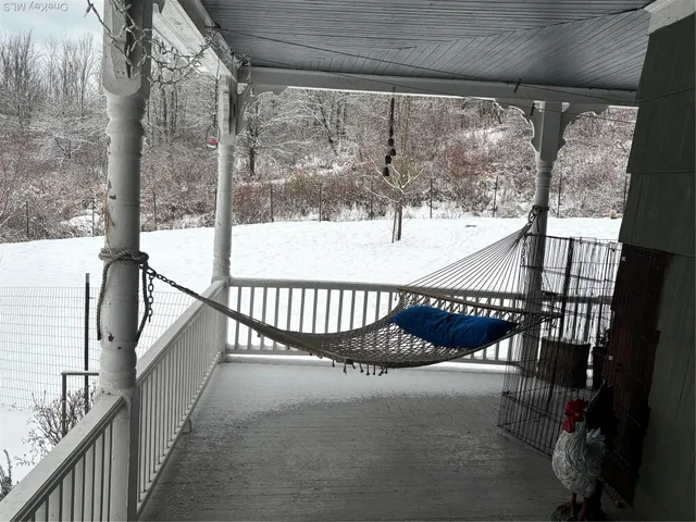 a living room with furniture a flat screen tv and a floor to ceiling window