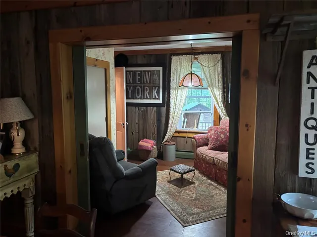 a living room with furniture a window and gym equipment