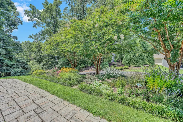 a kitchen with a table chairs refrigerator and wooden floor