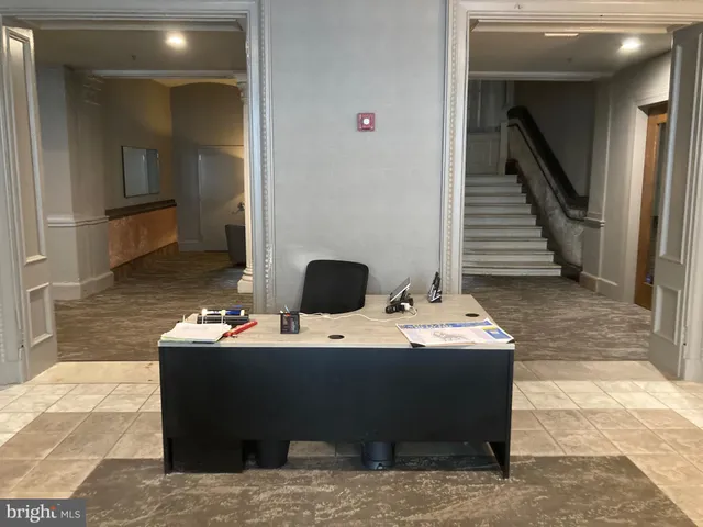 a living room with table and chairs