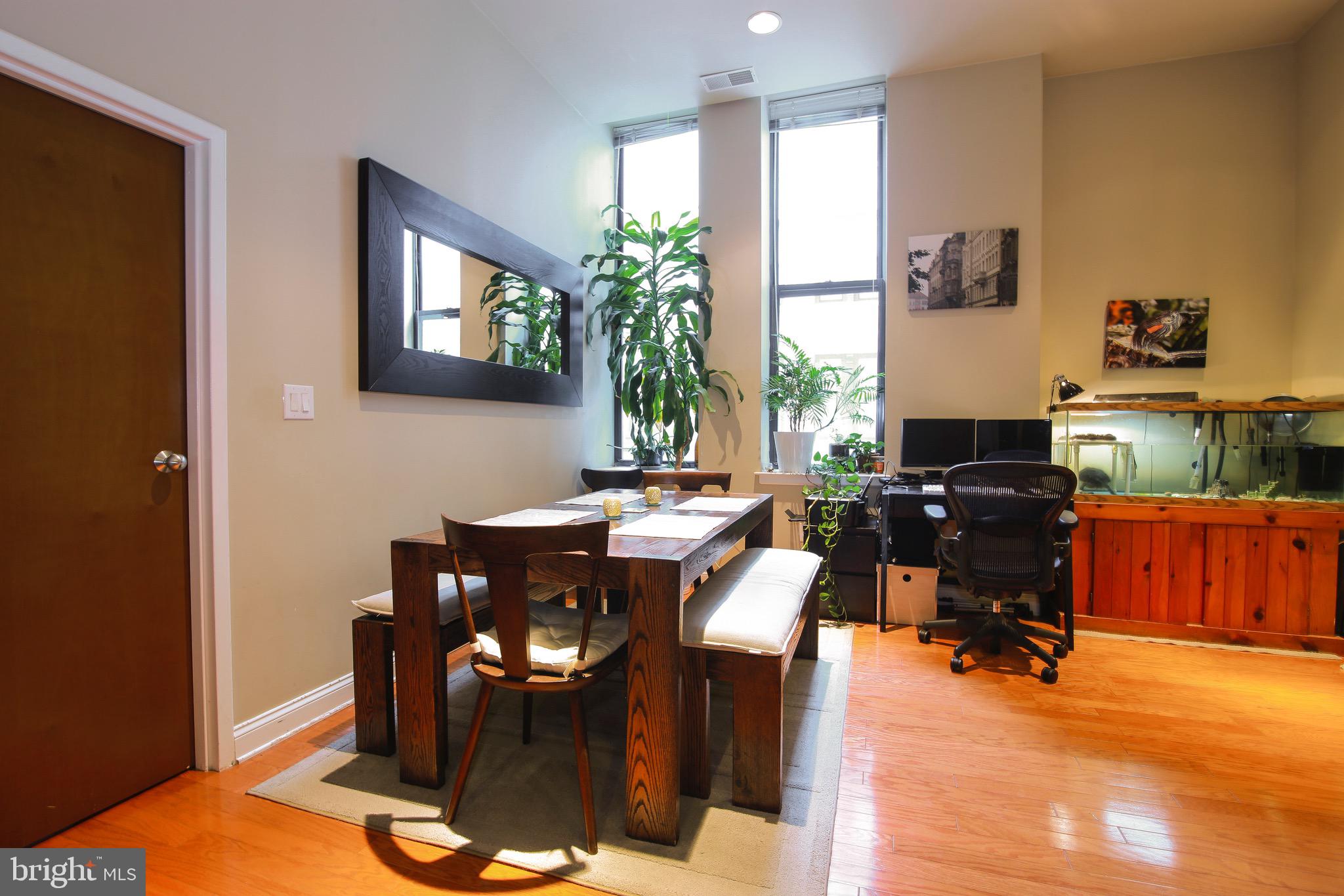 1001-13 Chestnut Street, Unit 705W Philadelphia, PA 19103 - Photo 28 of 30 a workspace with furniture window and wooden floor