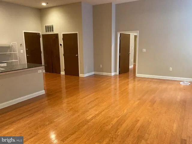 a view of a refrigerator in kitchen and wooden floor