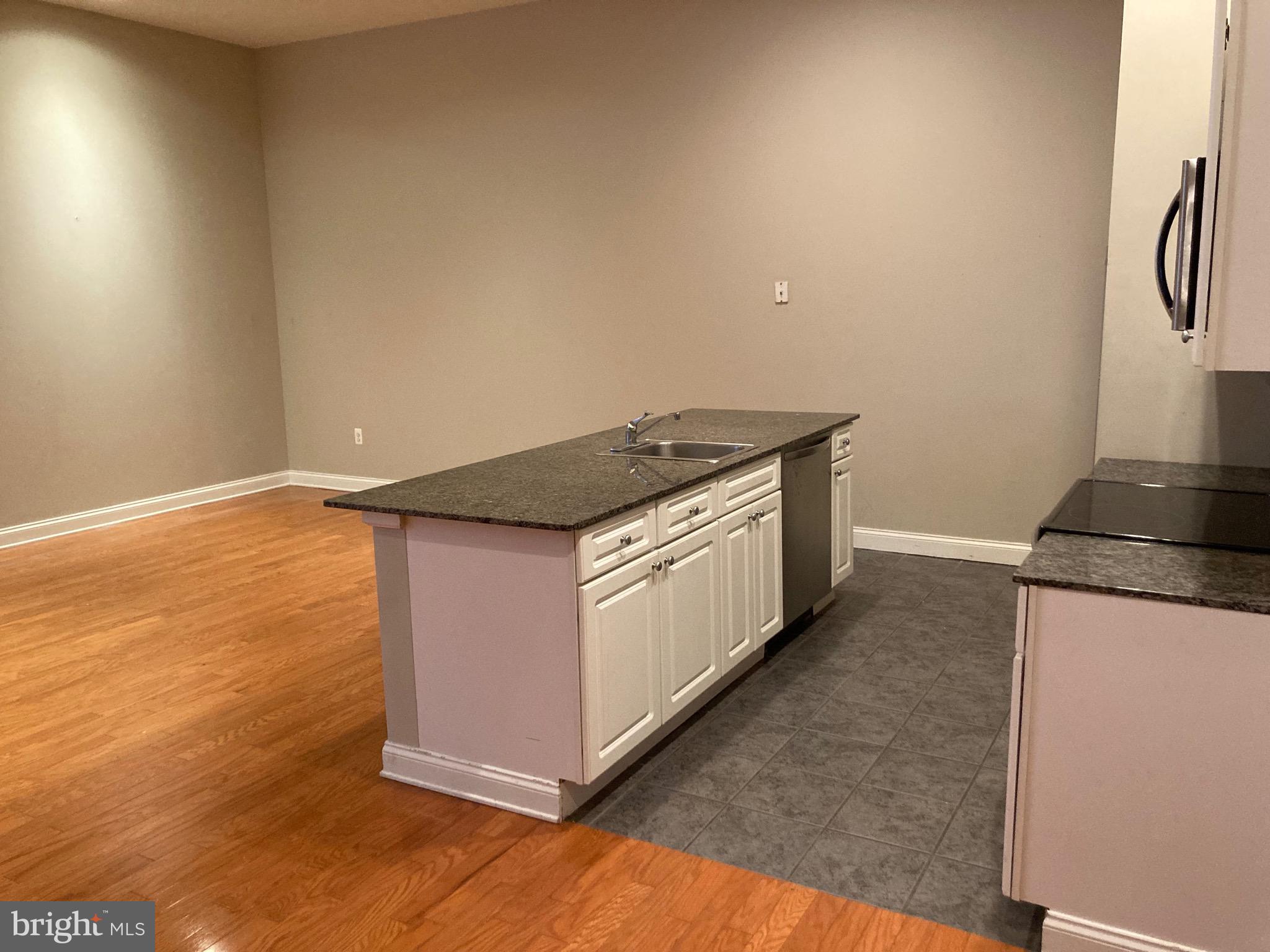 1001-13 Chestnut Street, Unit 705W Philadelphia, PA 19103 - Photo 9 of 30 a kitchen with granite countertop a stove and a refrigerator