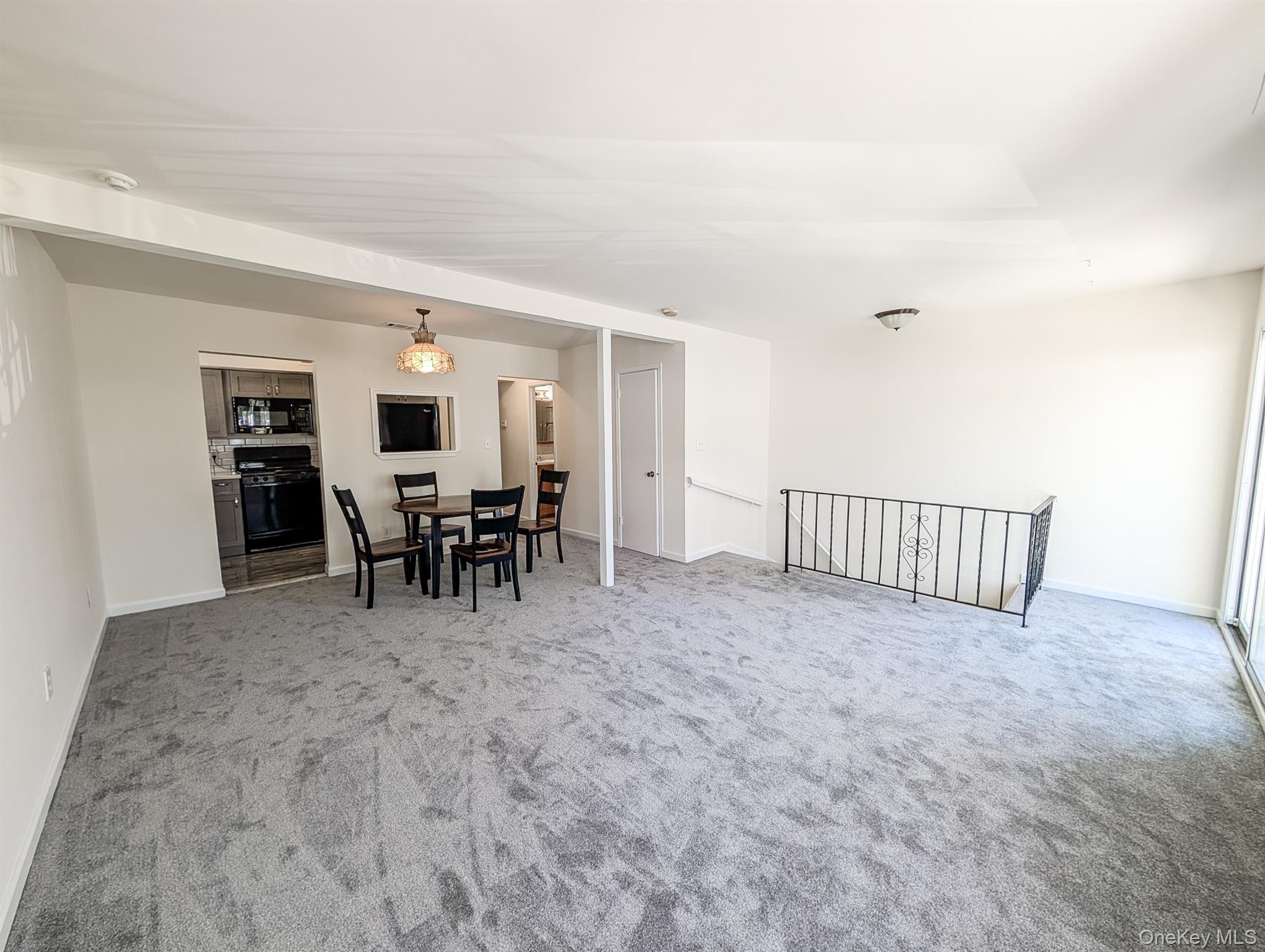 73 Rocky Point Yaphank Road, Unit 106 Rocky Point, NY 11778 - Photo 6 of 12 Dining room with light carpet and baseboards