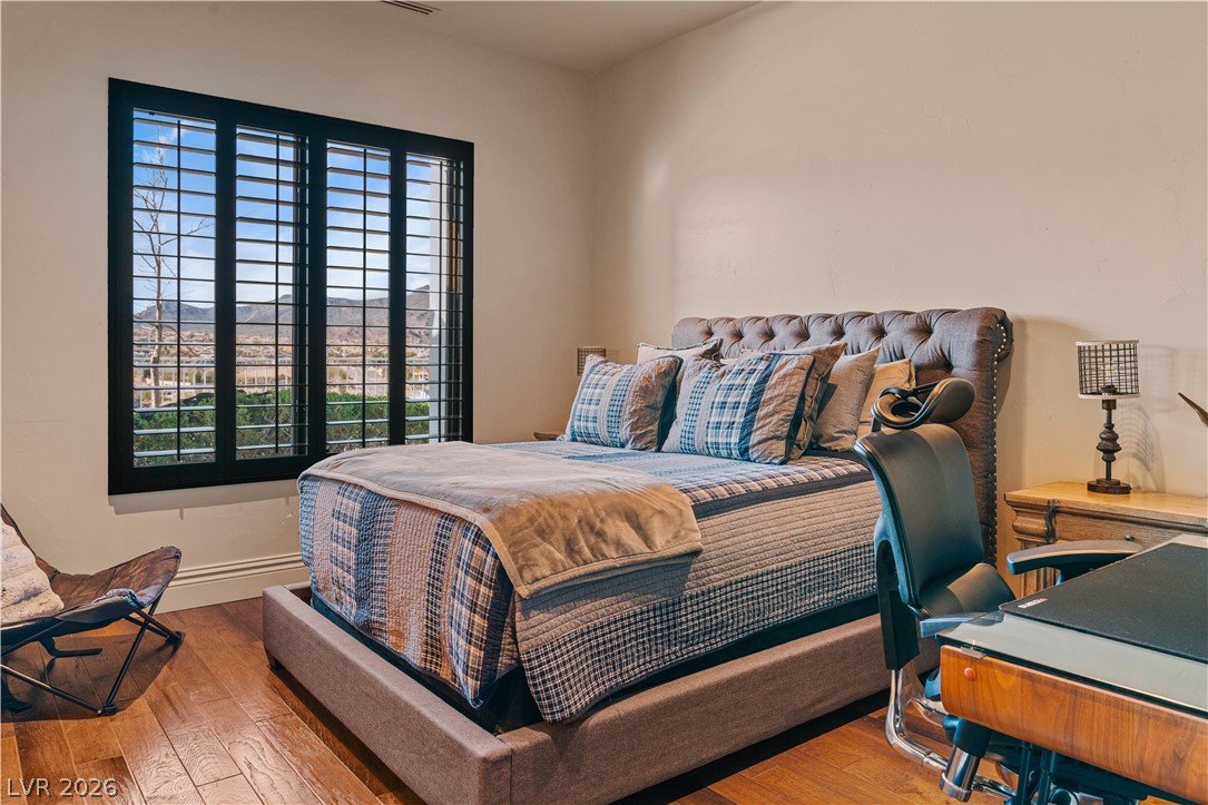 1123 Christian Road Henderson, NV 89002 - Photo 31 of 94 Hardwood floors and a wide window with a desert mountain view define this inviting bedroom.