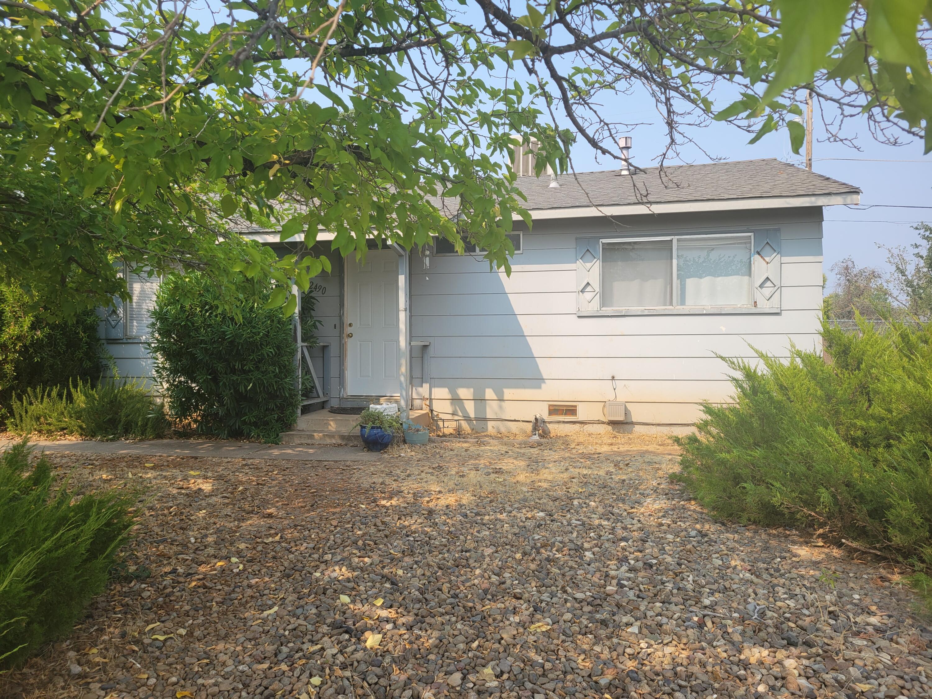 2490 Galaxy Way Redding, CA 96002 - Photo 4 of 30 a backyard of a house with plants and trees
