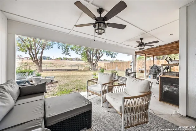 a dining room with furniture a rug and a floor to ceiling window
