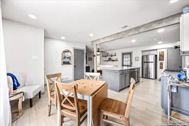 a view of a dining room with furniture and wooden floor