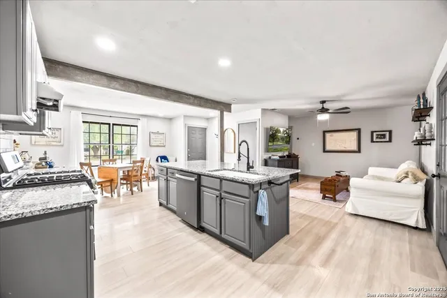 a large living room with stainless steel appliances granite countertop lots of counter top space and furniture