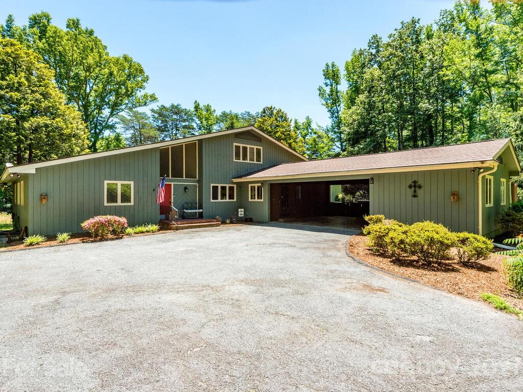 1032 Hooper Creek Road Tryon, NC 28782 - Photo 1 of 42 a front view of a house with a yard and garage