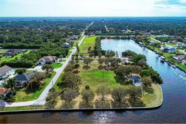 an aerial view of residential houses with outdoor space and lake view